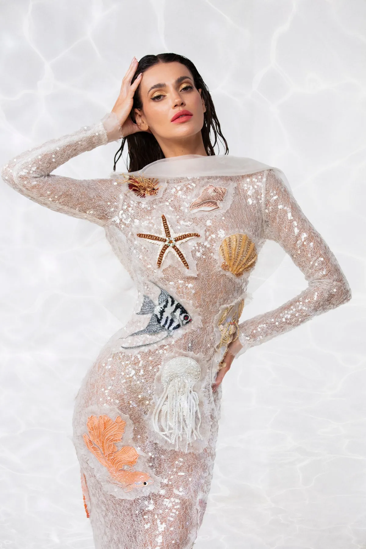 Patchwork of seashells and underwater creature embroidered onto a sequined white sheer tulle dress